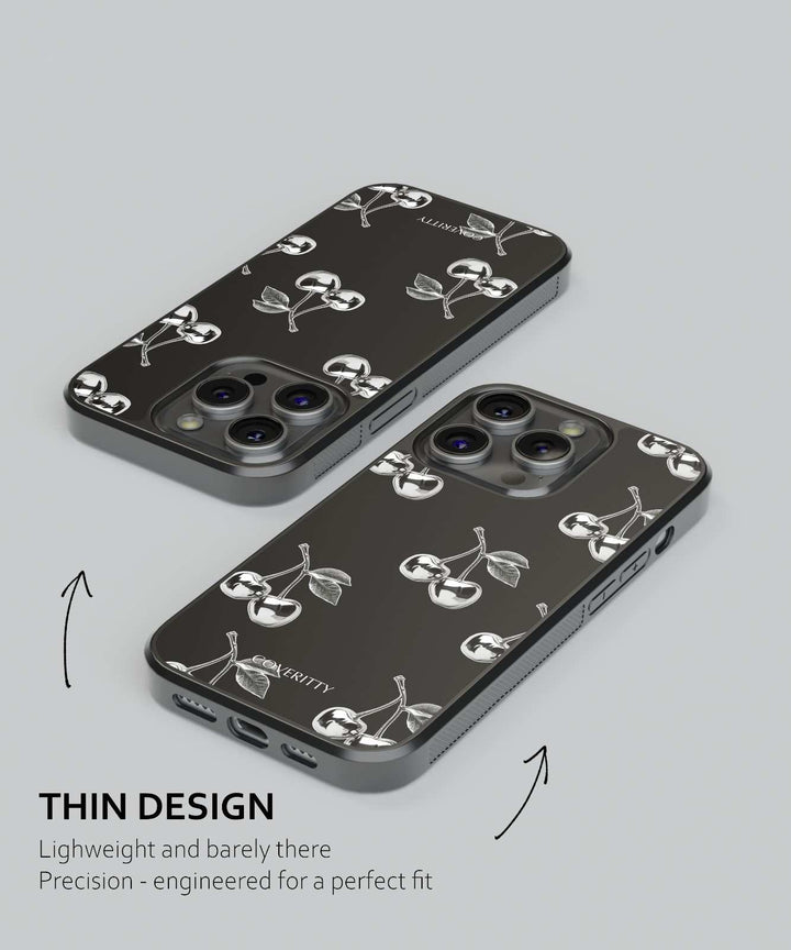 Two black phone cases with white designs on a gray background
