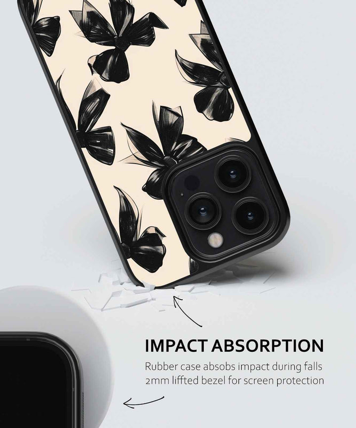 Phone case with black floral design on a light background, featuring text about impact absorption.