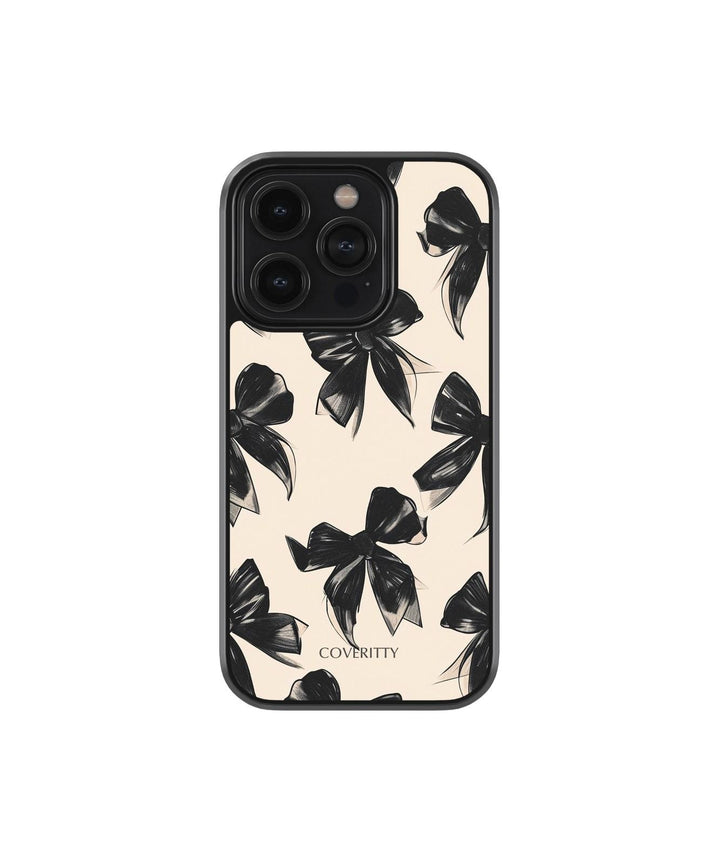 Phone case with black bow pattern on a beige background, featuring the brand 'Coverity'.