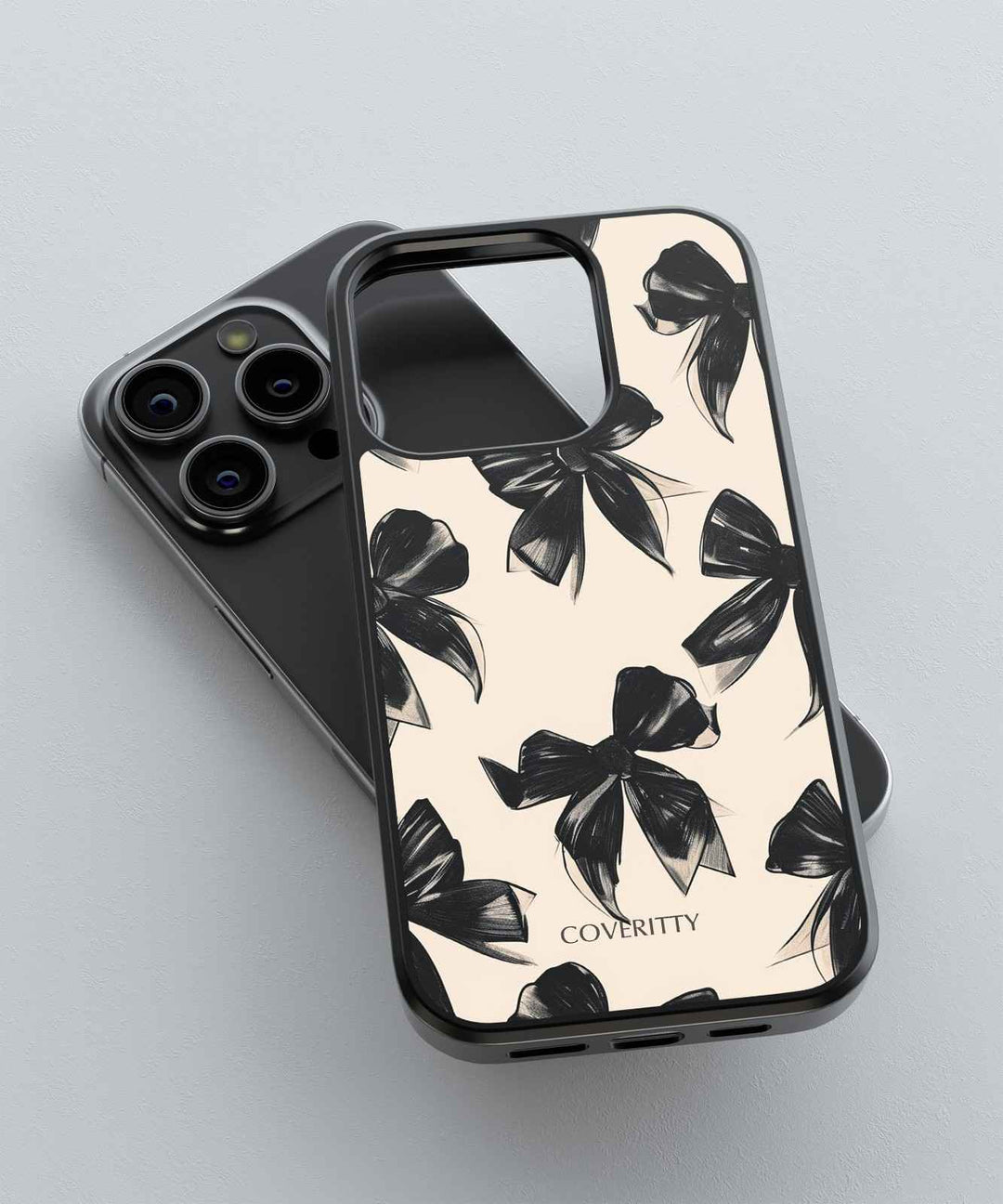 Phone case with black bow pattern on a light background, featuring the brand 'COVERITTY'.