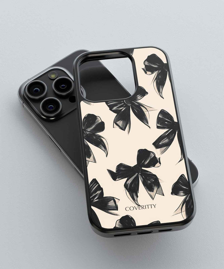 Phone case with black bow pattern on a light background, featuring the brand 'COVERITTY'.