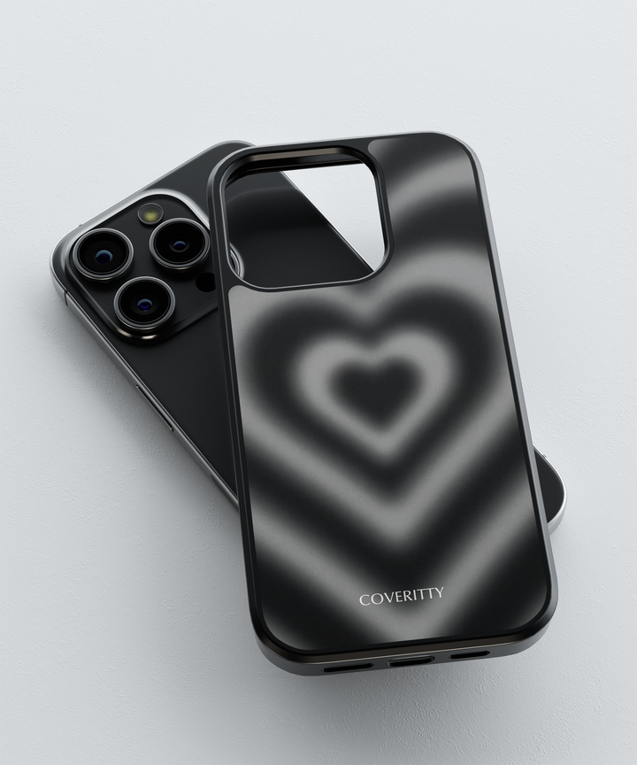 Phone case with heart design and 'COVERITTY' branding on a light gray background